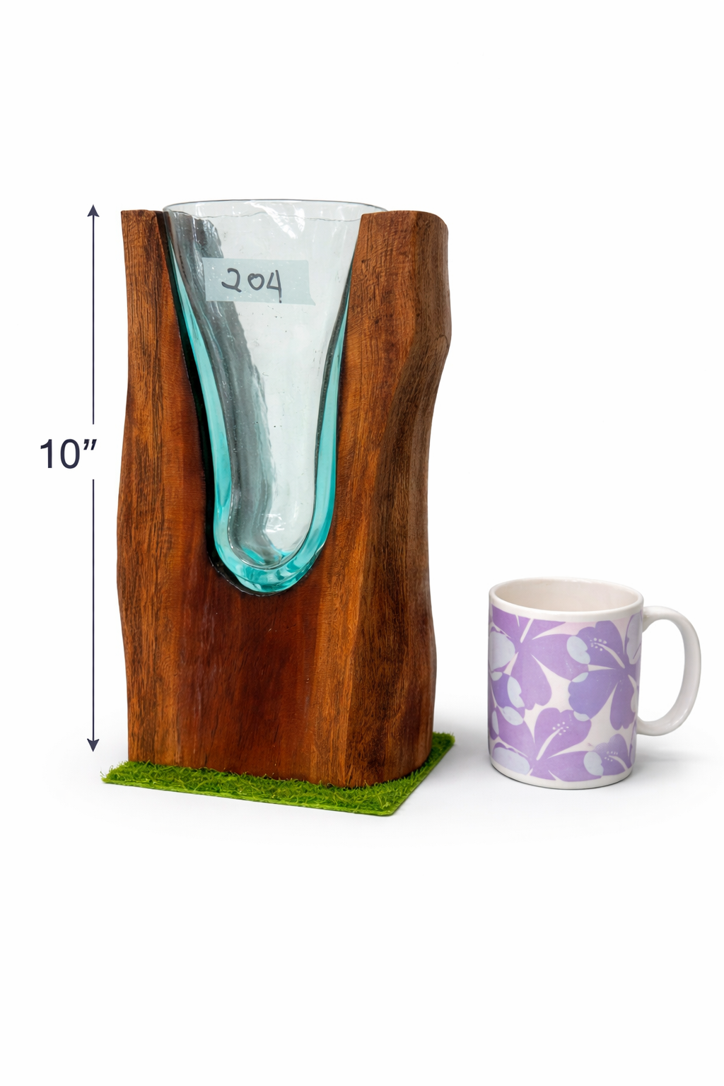 Wooden vase with glass insert next to a purple mug on a white background