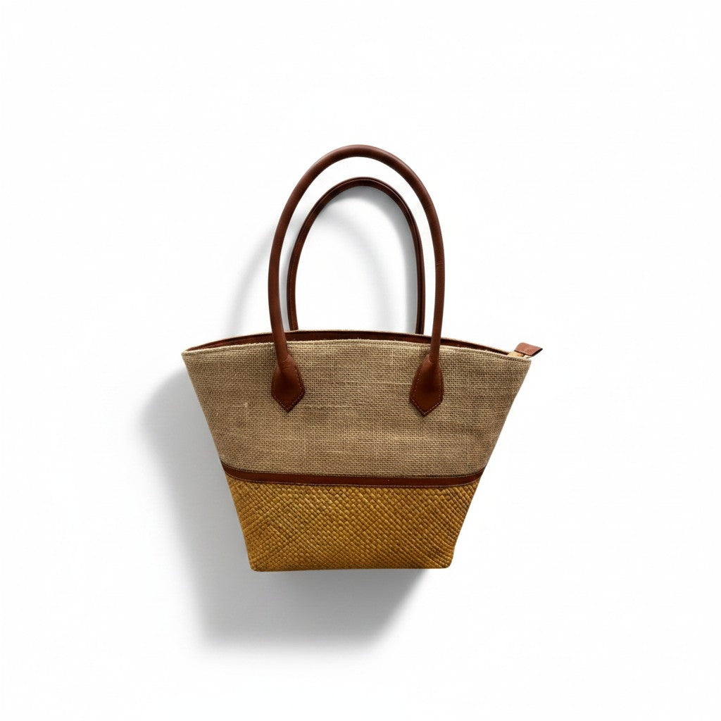 Brown woven handbag with leather accents on a white background