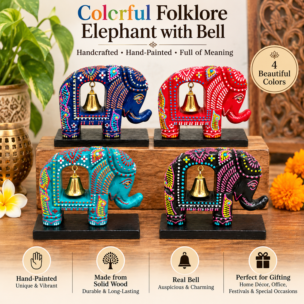 Four hand-painted wooden elephant bell ornaments in vibrant traditional Indian colors, displayed on a wooden surface with decorative plants and flowers. The text at the top reads 'Colorful Folklore Elephant with Bell' and highlights that they are handcrafted, hand-painted, made from solid wood, include a real bell, and are perfect for gifting.