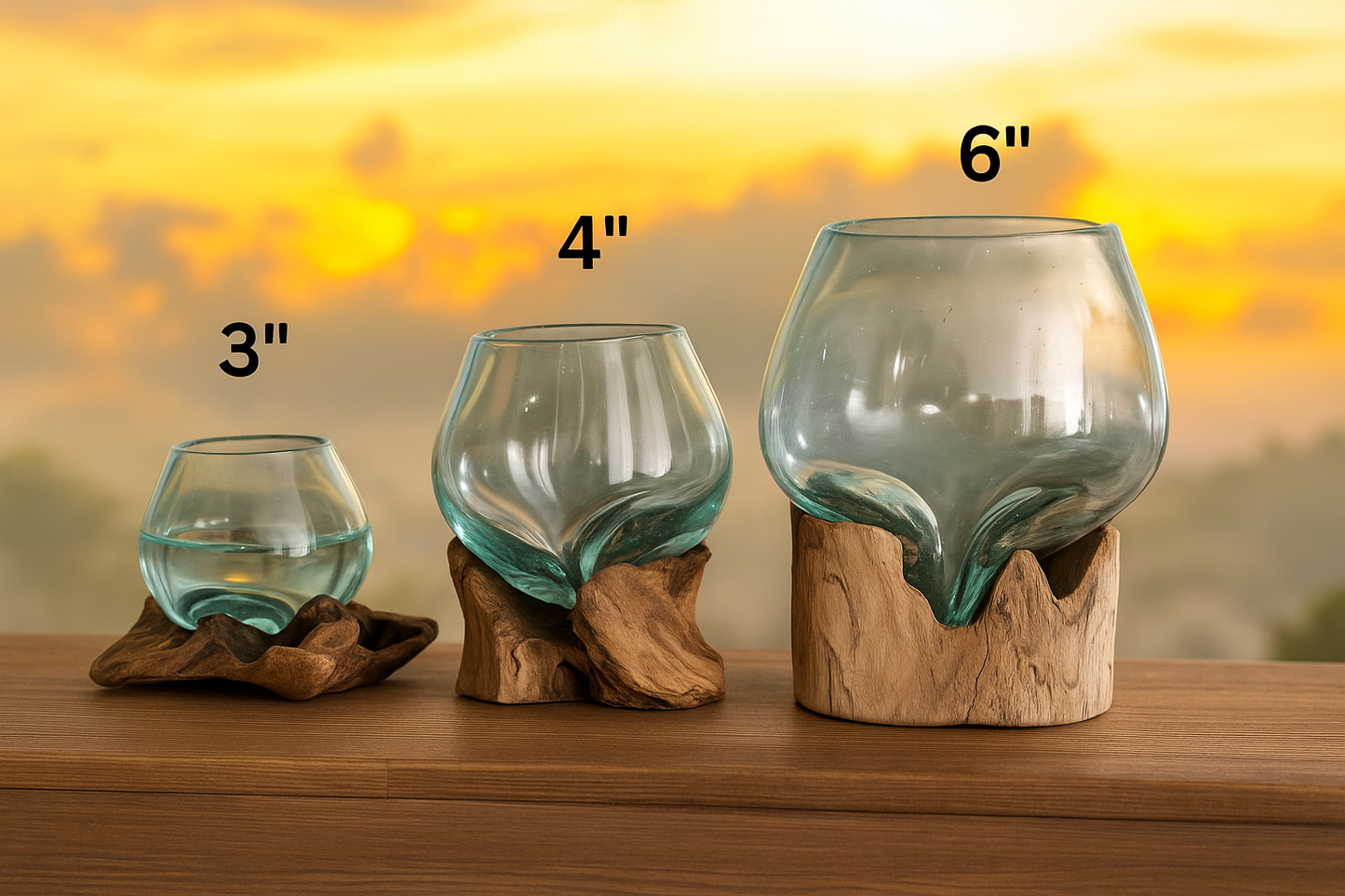 Three glass containers with wooden bases on a wooden surface against a sunset background