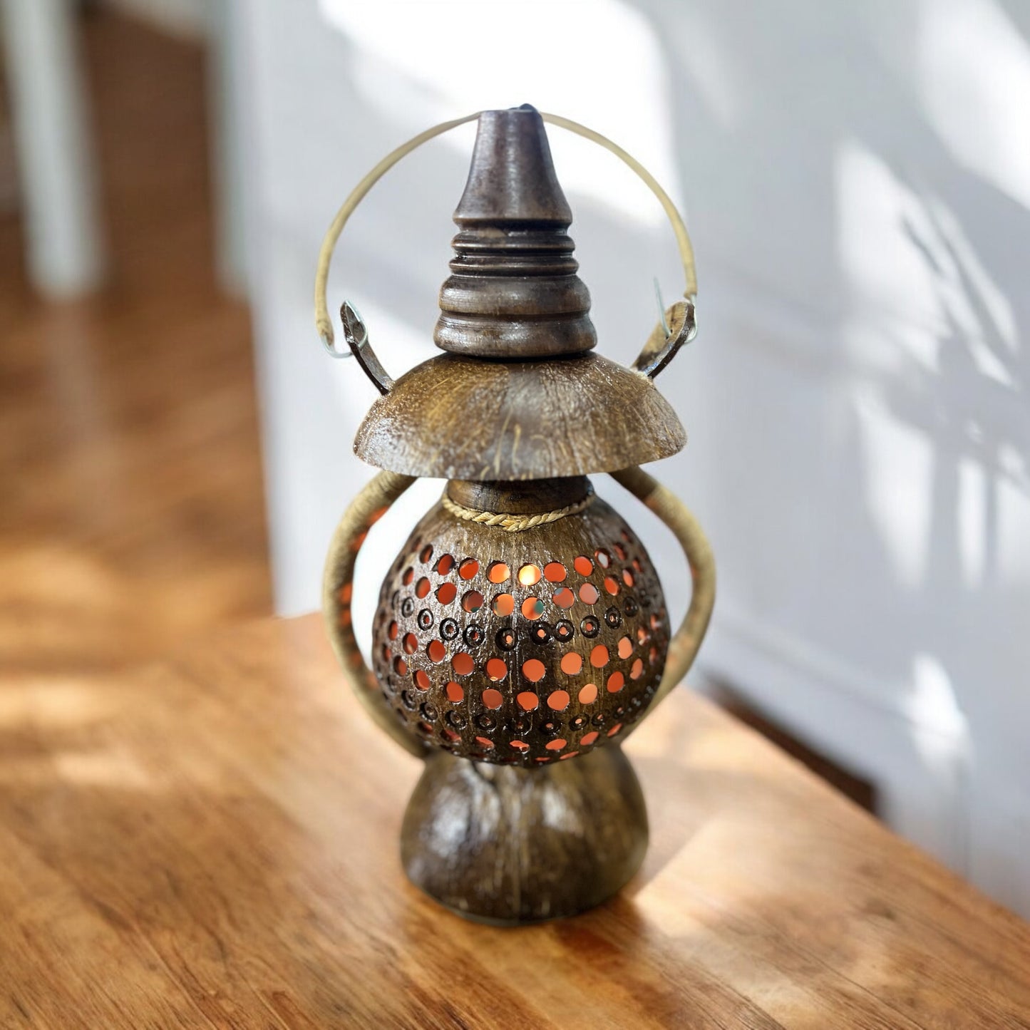 Decorative Coconut shell lantern on a wooden surface with a blurred background