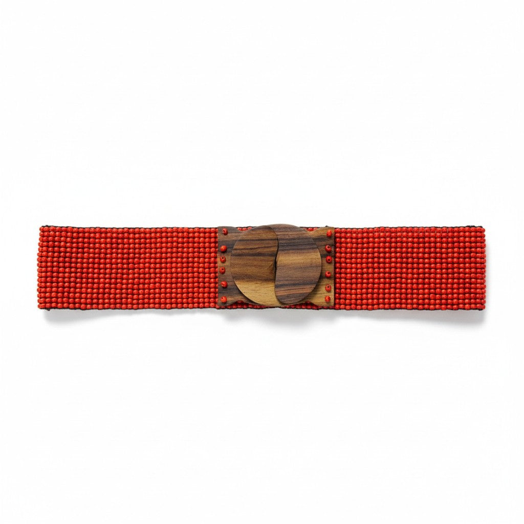 Red beaded belt with a wooden buckle on a white background