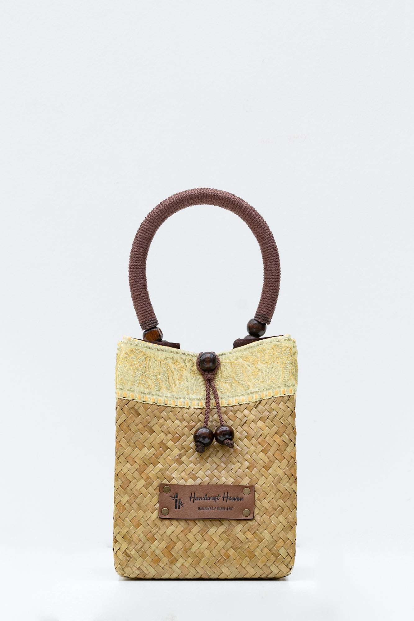 Woven handbag with a brown handle on a white background