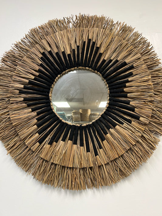 Inspired by the serene beauty of coastal landscapes, this round wall mirror exudes a relaxed and inviting vibe. The intricately woven seagrass frame adds texture and depth to any room, creating a focal point that captures the essence of seaside living.