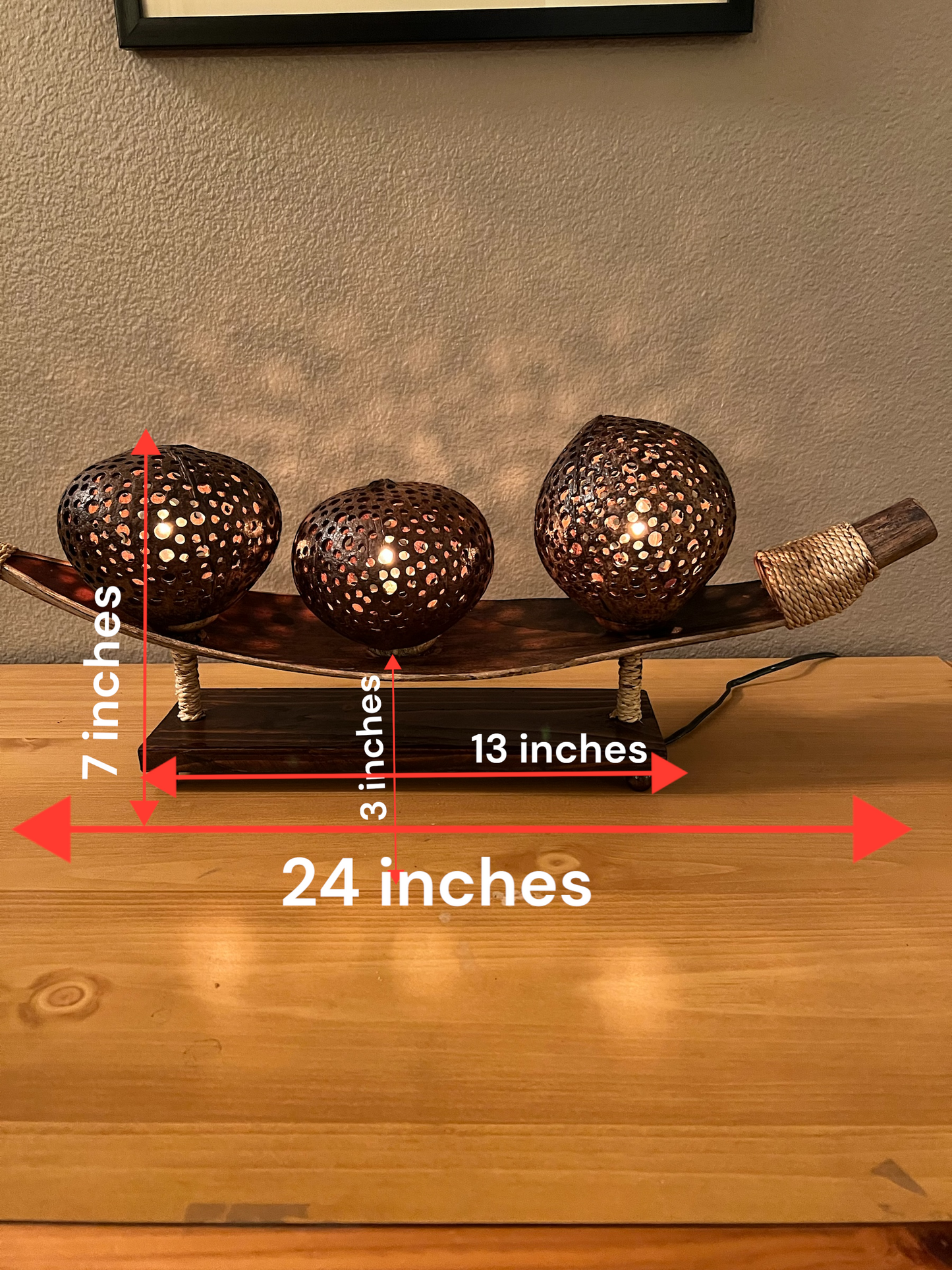 Decorative coconut shell table lamp with dimensions labeled on a wooden surface