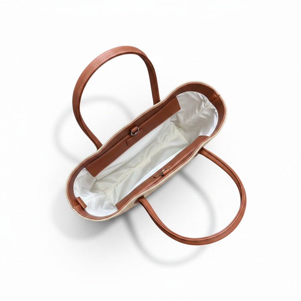 Brown handbag with white interior on a white background