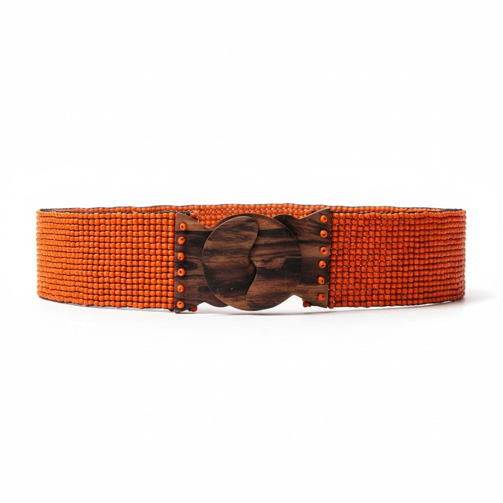 Orange belt with a wooden buckle on a white background