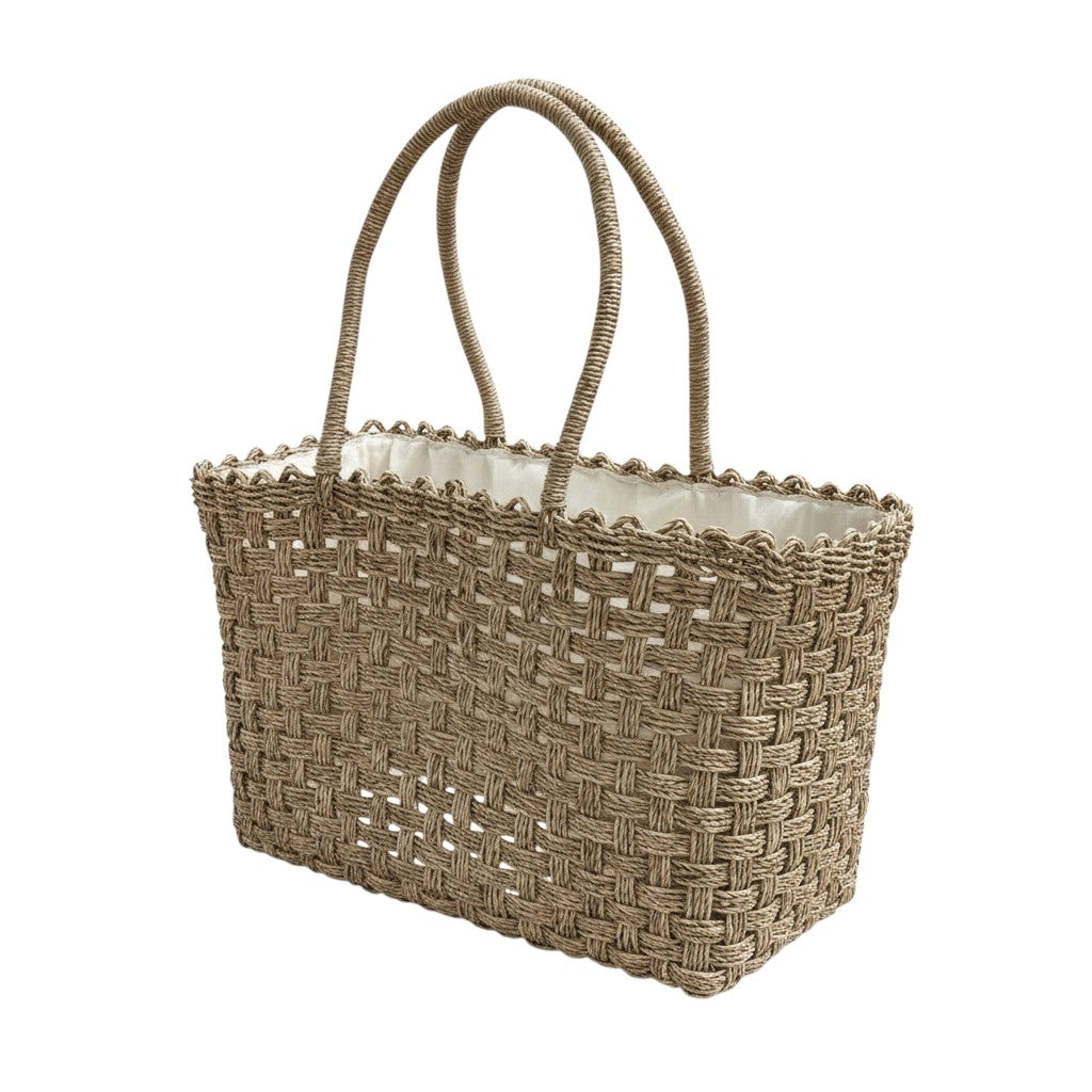 Woven straw tote bag with a scalloped edge on a white background