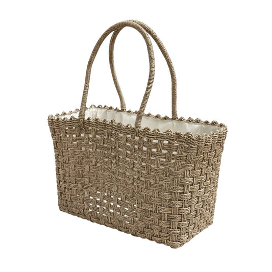 Woven straw tote bag with a scalloped edge on a white background