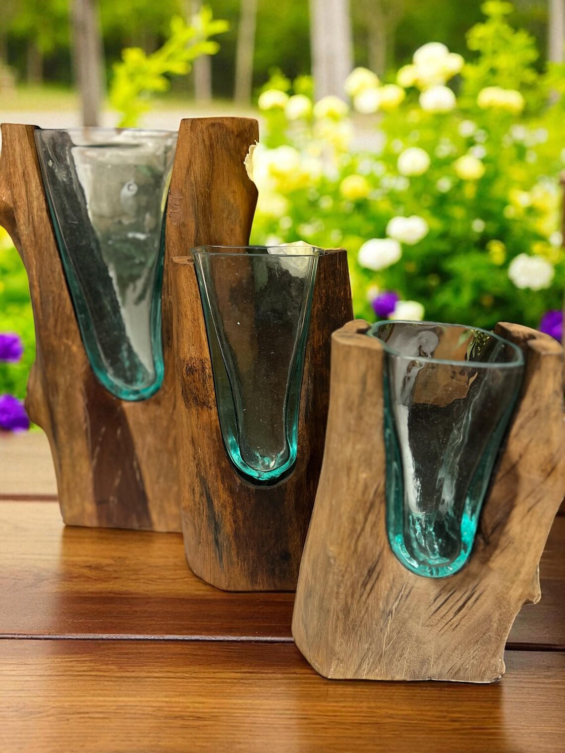 Close-up of melted glass shaping around teakwood base