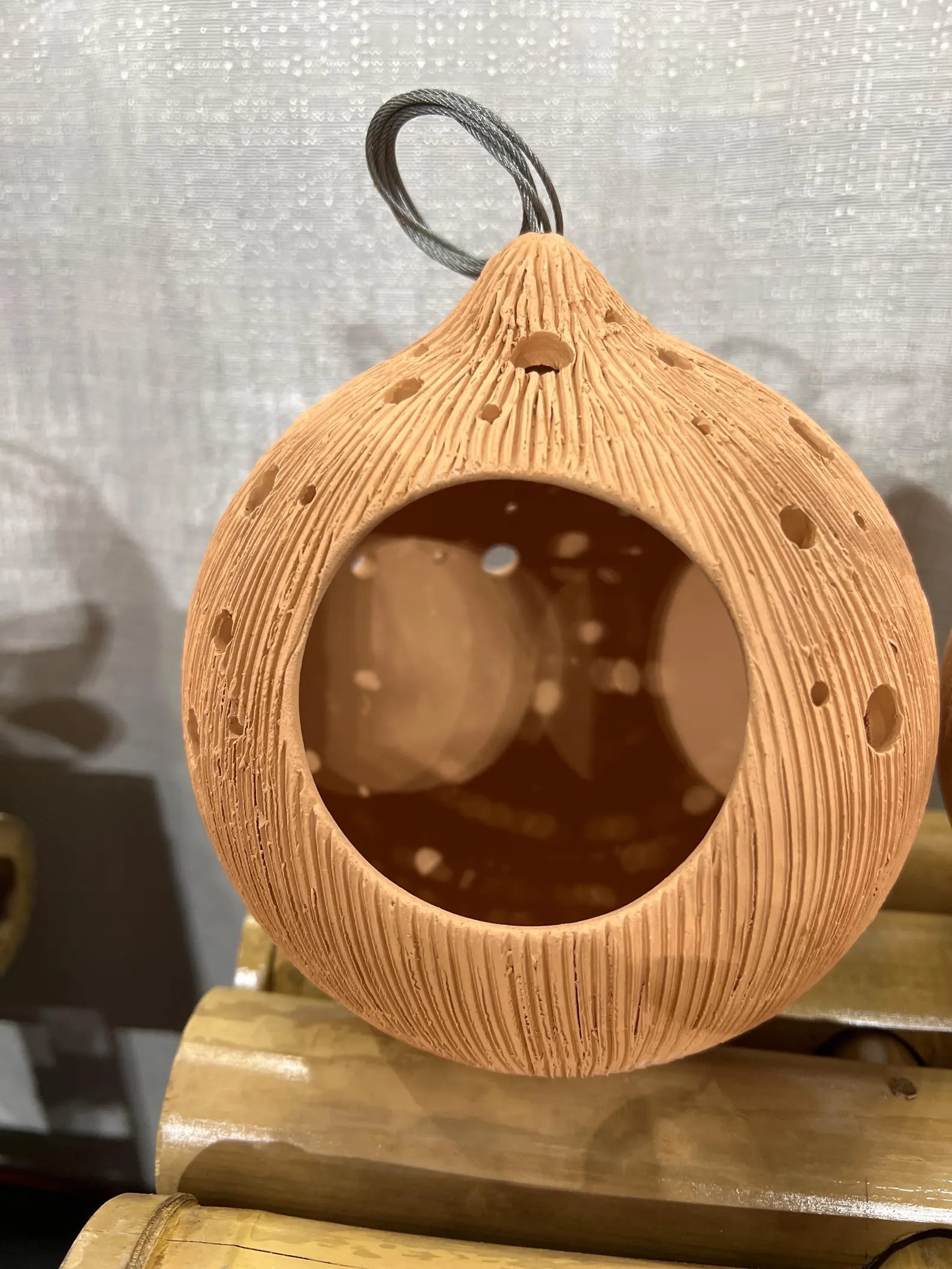 Textured brown Terracotta pots on a wooden surface with a neutral background