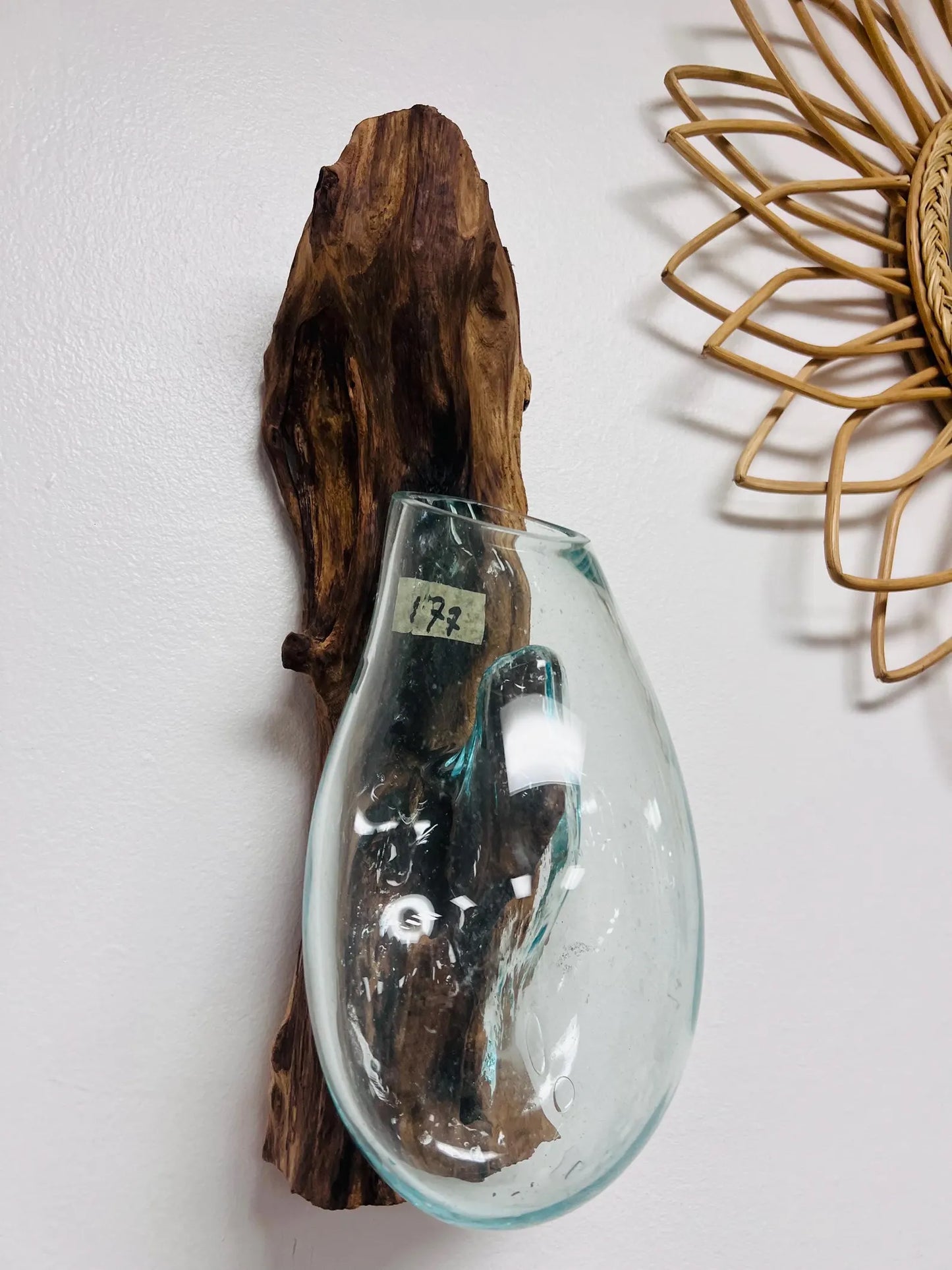 Clear glass vase with a wooden piece on a white background
