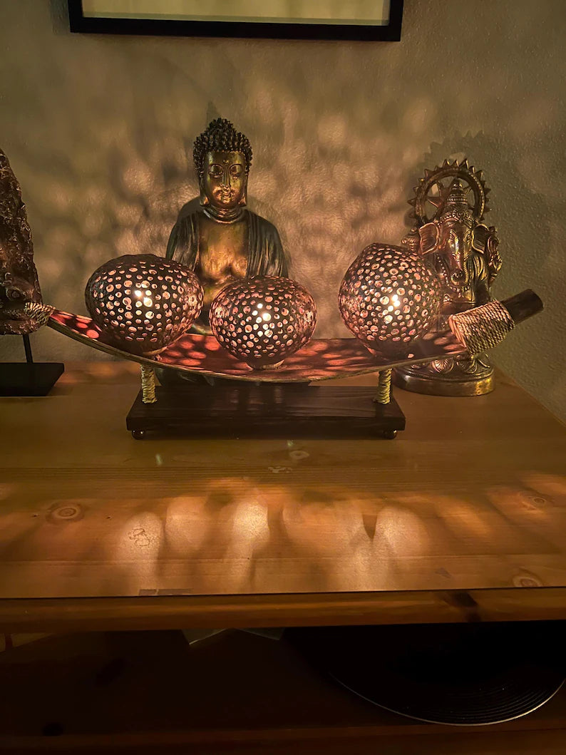 Decorative coconut shell table lamp with a Buddha statue 
