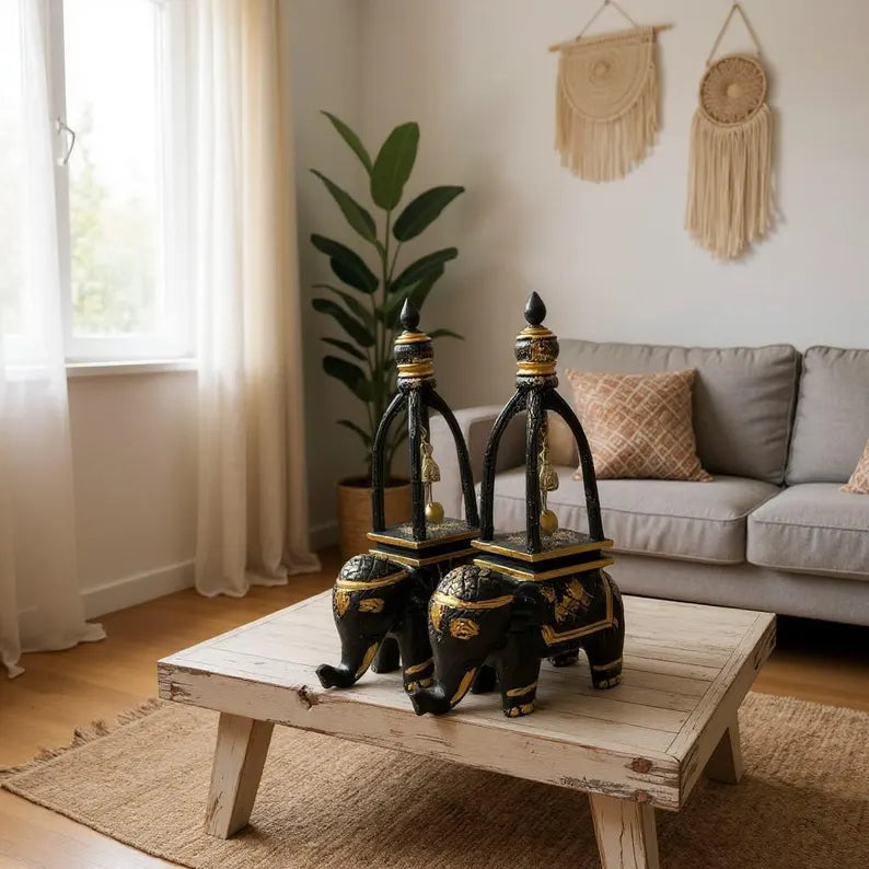 Decorative elephant statues on a wooden coffee table in a living room.
