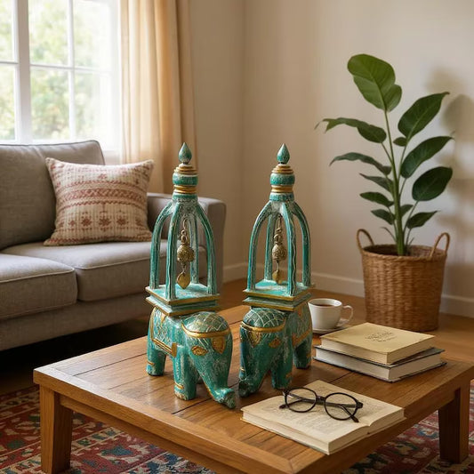 Decorative teal elephant decor with bells on a wooden coffee table in a living room.