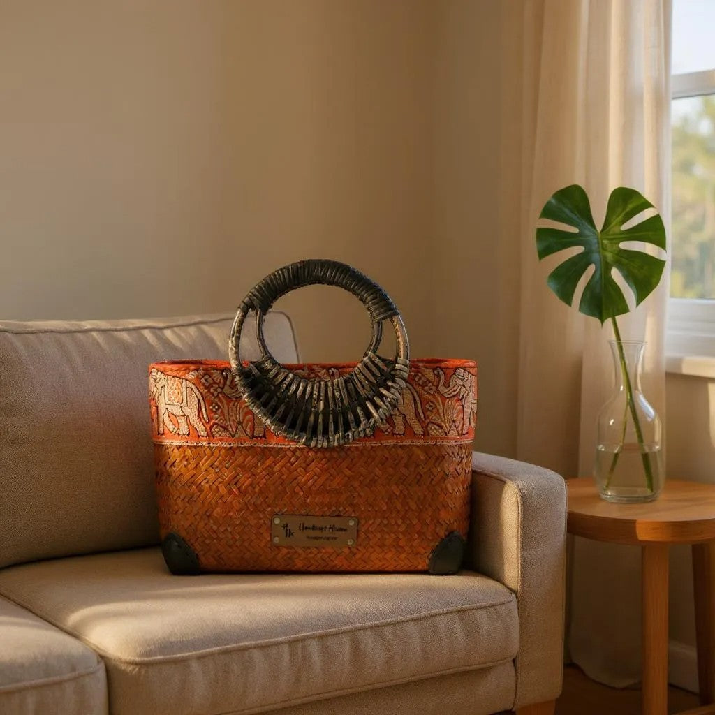 Orange Handwoven straw bag with bamboo handle and silk border detail