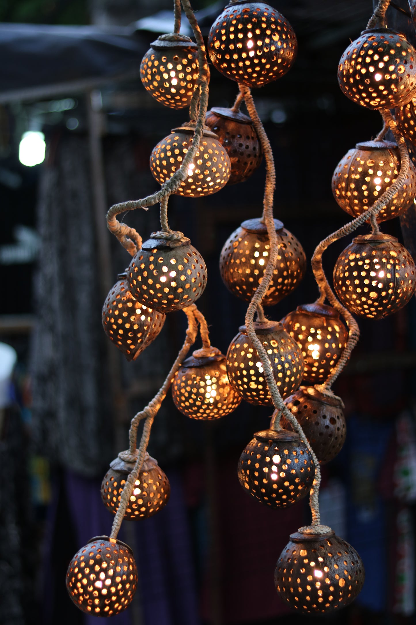 Decorative coco string lights with spherical lanterns on a dark background