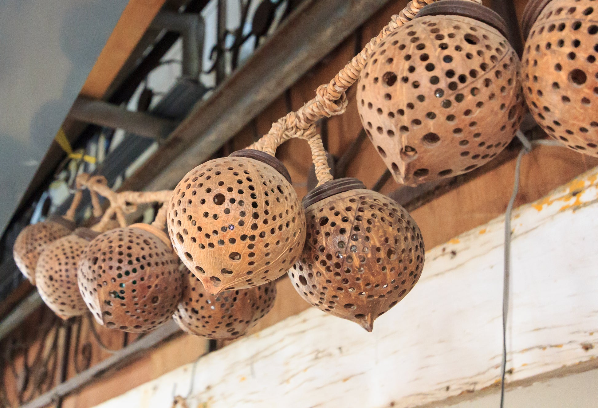 Decorative coco string lights with a textured surface on a wooden shelf.